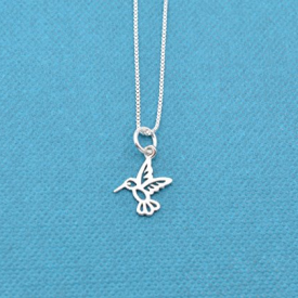 Little girls tiny hummingbird charm necklace in sterling silver on a sterling silver 14 sterling silver box chain. Little girls jewelry. Hummingbird necklace. Hummingbird jewelry. 14 + 2 extender.
